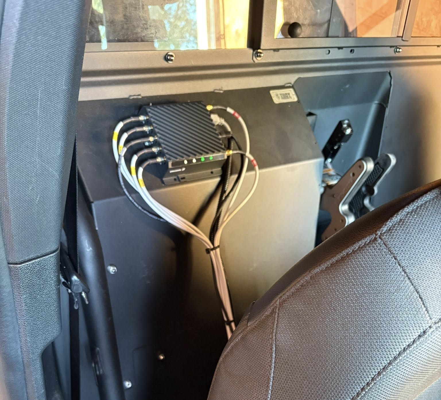 Professionally bundled automotive wiring harness behind a vehicle dashboard