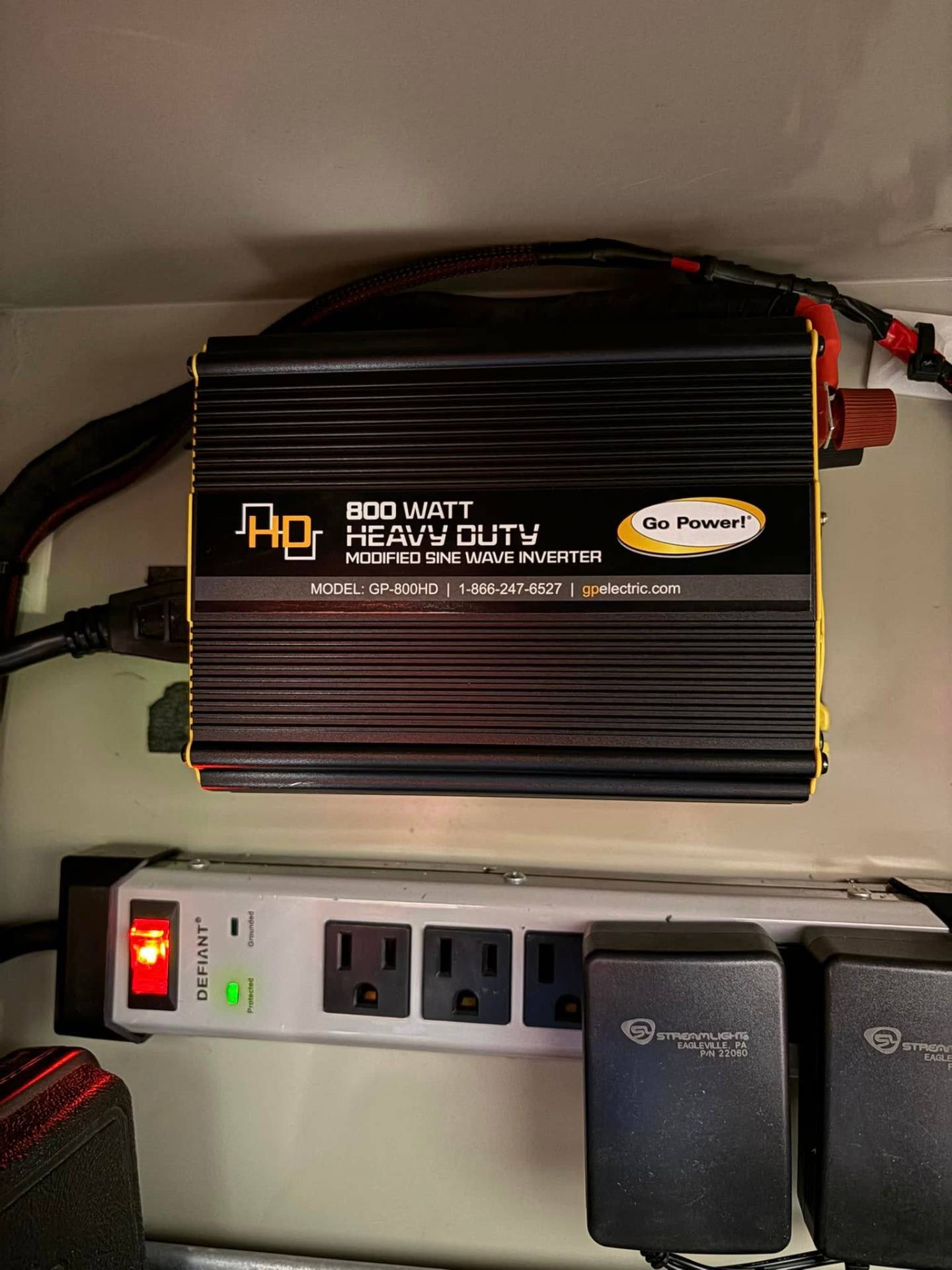 Go Power 800-watt heavy-duty inverter mounted in an emergency vehicle with power strip and Streamlight chargers wired in