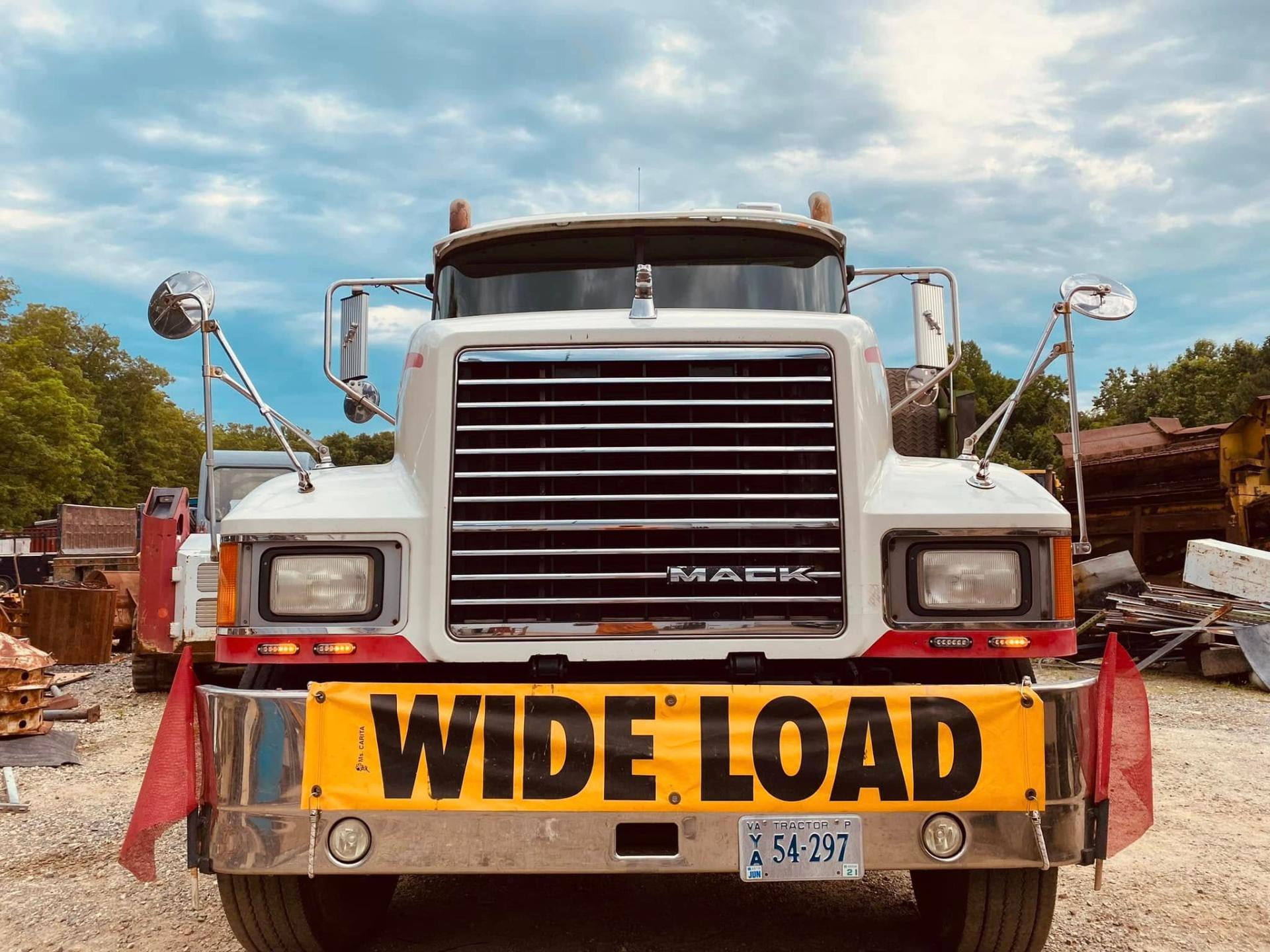 Orange municipal utility bucket truck working roadside with amber warning lighting